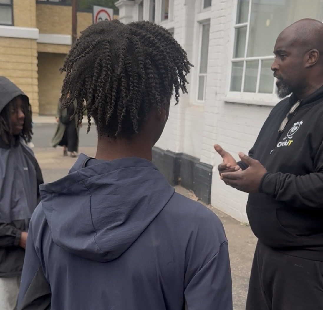 ClockiT mentor talking with a young person outside a session