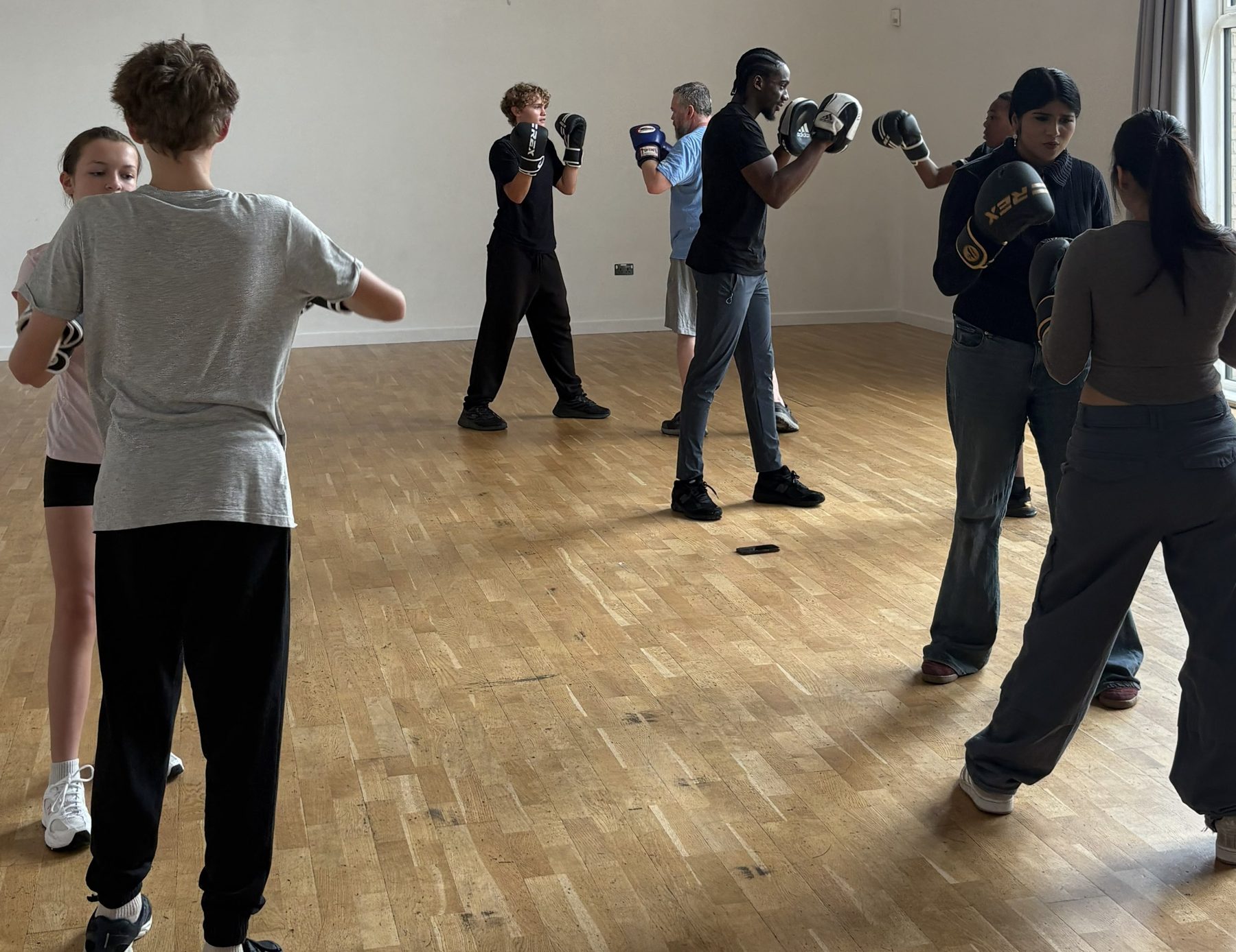 Young participants training with boxing gloves in a ClockiT session